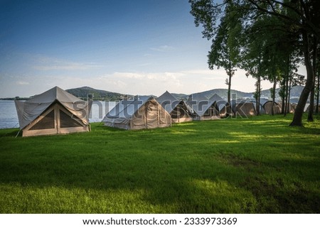 Tents for camping on the lawn on a sunny day, travel theme.