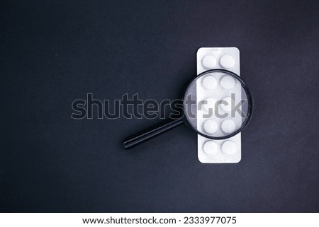 magnifying lens and medicine. the concept of finding a cure. medical concept Royalty-Free Stock Photo #2333977075