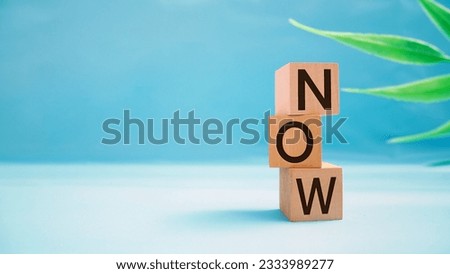 NOW message on blue background. Now made with building blocks with copy space available.Business Concept image.