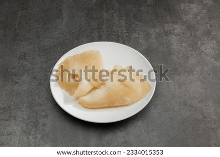 Shark fins food raw material premium ingredient for fine dining cooking. Dry Shark fin isolated on plate marble background