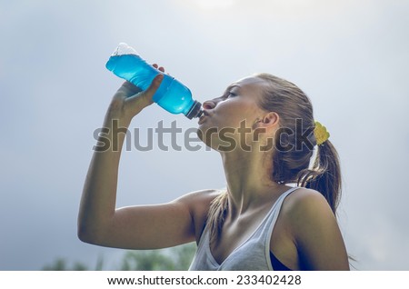 thirsty athlete drinking power drink after long run