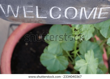 a decorative designed welcome sign on the threshold of the home.
