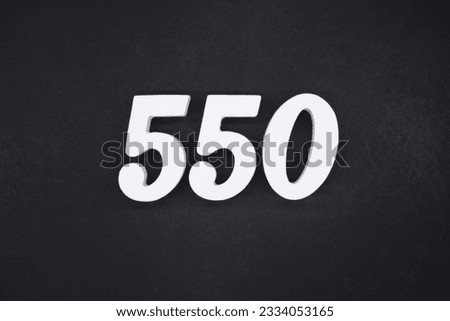 Black for the background. The number 550 is made of white painted wood.