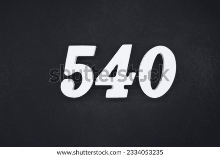 Black for the background. The number 540 is made of white painted wood.