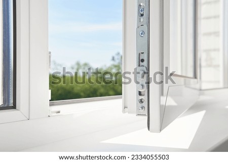 PVC window frame open closeup view. Bottom window frame detail. Room open window ventilation. Royalty-Free Stock Photo #2334055503