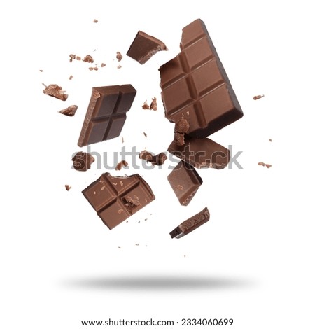 Broken chocolate bar pieces falling on white background Royalty-Free Stock Photo #2334060699