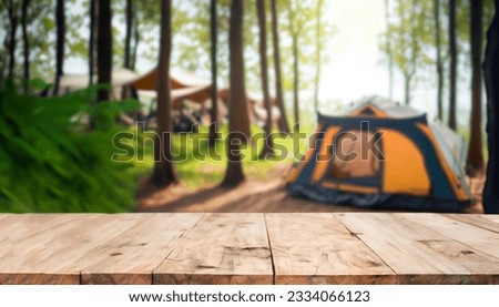 Wood table and Blurred camping and tents in forest. Royalty-Free Stock Photo #2334066123