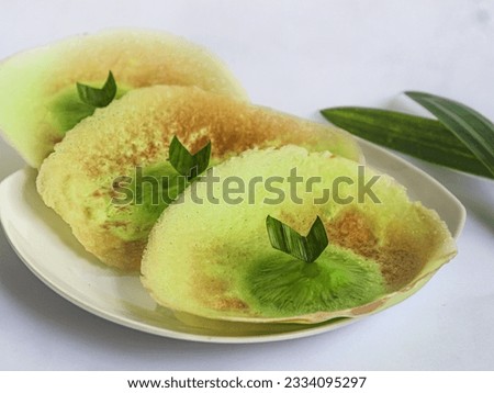 Kue Ape or Serabi Jakarta is a traditional snack from Jakarta, which resembles a pancake in shape. This treat is commonly sold on the streets or in front of schools and is made from a mixture of wheat Royalty-Free Stock Photo #2334095297