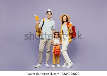 Traveler parents mom dad with child girl wear casual clothes hold passport ticket bag isolated on plain purple background. Tourist travel abroad in free time getaway. Air flight trip journey concept