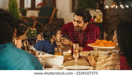 Family Time and Good Happy Memories: Indian Father Feeding his Son and Sharing Traditional Food on a Family Dinner. Family Bonding Memories Full of Love and Affection Royalty-Free Stock Photo #2334107375
