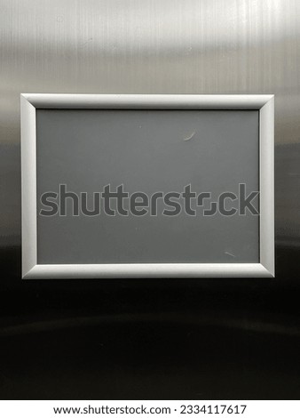 A rectangle metal sign display inside elevator, copy space