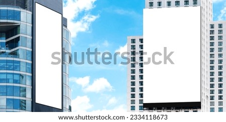 Two outdoor billboard on building  with blue sky background