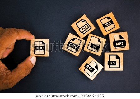 wooden box with save file icon or download file format DOC, JPG,RAR, TXT, XLS, CSV, DLL And MP3 file. file icons are arranged into folders. Concept document management system or DMS.