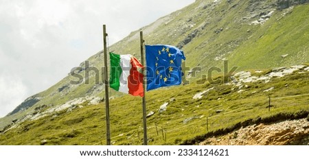 ITALY AND EUROPE FLAGS ON MOUNTAIN LANDSCAPE STATE BORDER