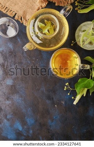 Herbal organic natural linden blossom tea in glassware with copy space. Healthy, warm beverage. Rustic background.