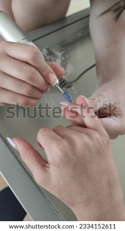 master makes manicure, manicure process, fingers in the process, female hands