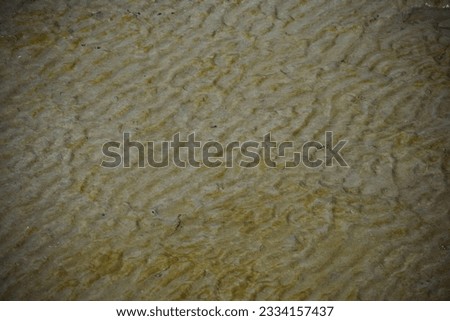 Natural sand pattern on flat sandy beach during low tide.Natural sand pattern on flat sandy beach during low tide.selective focus.