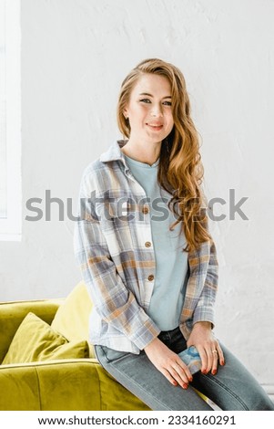 Young beautiful long haired college student girl in casual shirt with mobile cell phone.Businesswoman calling,speaking.Typing love message,chat,date in social network with boyfriend.Business planning.