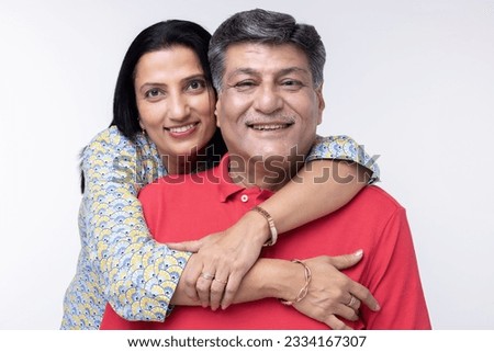 Portrait of loving senior couple over white background