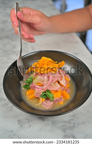 Caucasian Woman's Hands Holding a Delicious Ceviche Plate on White Table Background
