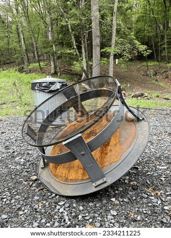 A small fire pit that has been turned upside down to drain.