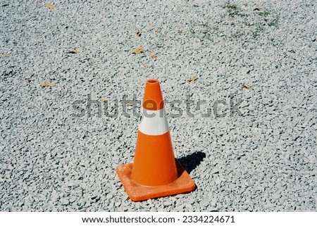 orange traffic cone on the stone ground