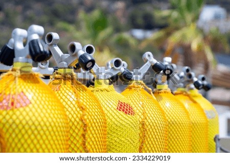 scuba tanks of diving center with air nitrox or trimix in marina port  for courses or dive trips Royalty-Free Stock Photo #2334229019