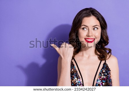 Photo of dreamy tricky lady wear sequins dress pointing thumb looking empty space isolated purple color background