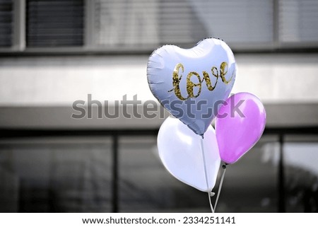 Heart shaped balloon with Love inscription. Horizontal image with selöective focus.