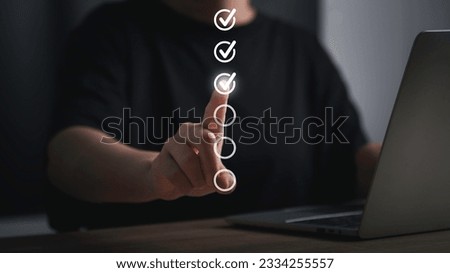 Digital work checklist or electronic smart daily checklist concept. Check mark on virtual screen for personal working in office  Management System and  Boost Productivity process automation. Royalty-Free Stock Photo #2334255557