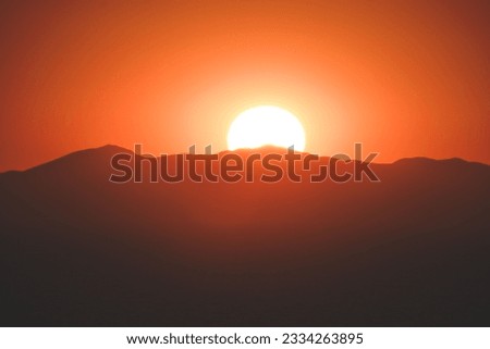 A beautiful view of mountains during orange sunset