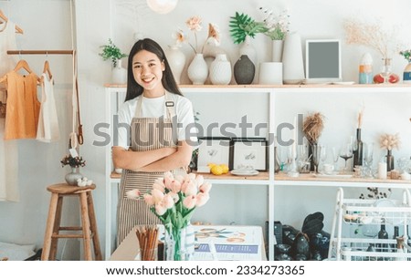 Small business owners pose smiling in their small shop to welcome customers and get customers online. And check the orders that customers have ordered of online retailers - online shopping.