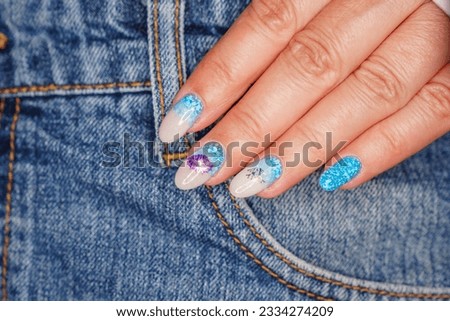 Manicure in the marine style.  Photos with beautiful well-groomed female nails. Selective focus.