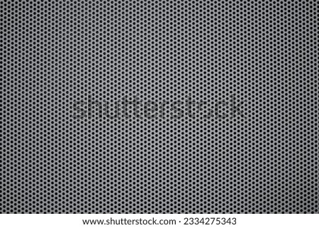 Perforated gray and metal grid, steel with black hole grilles for the background.  Pattern of dots. Protective grating surface.