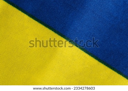 Flag of Ukraine, blue and yellow fabric close-up. The concept of the departure of Ukrainians abroad or the stay of Ukrainian citizens outside the state in connection with the war with Russia