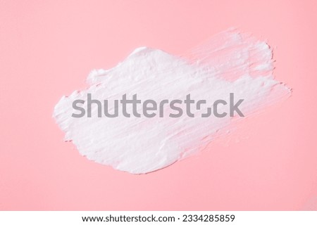 Smear of white face or body cream, lotion, mousse, soap, shower gel on pink background. Cosmetics texture. Spa, skin care, beauty and health, medicine. Cosmetic background, mockup
