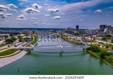 An aerial shot of the Iowa Women of Achievement Bridge across the Des Moines River in Downtown Des Moines, Iowa