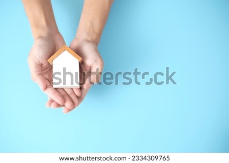 Property, house insurance protection concept. wood model house in hands. house care. Royalty-Free Stock Photo #2334309765