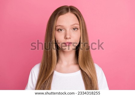Photo of serious concentrated focused girl calm face look camera isolated on vibrant pink color background
