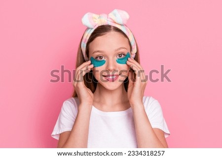 Portrait of adorable happy person hands touch apply under eye pampering patches isolated on pink color background