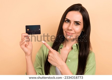 Photo of nice charming person indicate finger arm hold plastic debit card isolated on beige color background