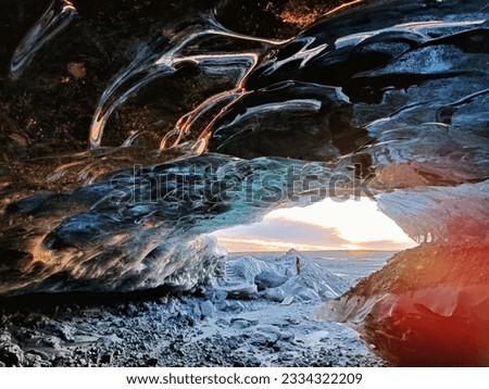 The ice cave of the Katla volcano with the sunset in the background in Iceland Royalty-Free Stock Photo #2334322209