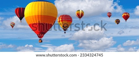 Hot Air Balloon Ride in blue sky white clouds background for wide banner of travel agency or adventure tour. Romance of ballooning in a good weather. Hot air balloons flies in blue sky. Copy space Royalty-Free Stock Photo #2334324745