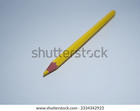 a yellow pencil on a white background