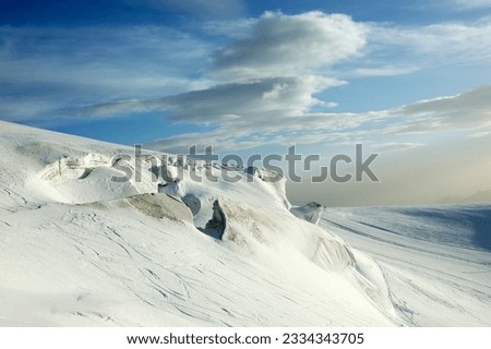 Detail of mountain glacier over cloudy sky