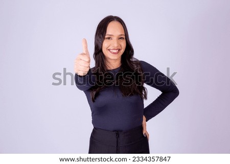 Young pretty woman with thumb up making ok sign