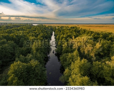 Aerial view of the river, forest and fields in the light of the rising sun. Kherson region, Kherson, Ukraine. Royalty-Free Stock Photo #2334360983