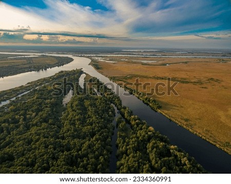 Aerial view of the river, forest and fields in the light of the rising sun. Kherson region, Kherson, Ukraine. Royalty-Free Stock Photo #2334360991