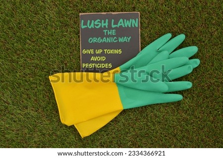 Blackboard (Lush Lawn The Organic Way. Give Up Toxins. Avoid Pesticides) Rubber Gloves on turf grass