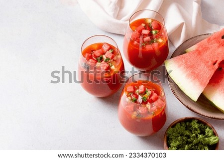 Spanish tomato and watermelon gazpacho cold soup styled and decorated in glasses Royalty-Free Stock Photo #2334370103